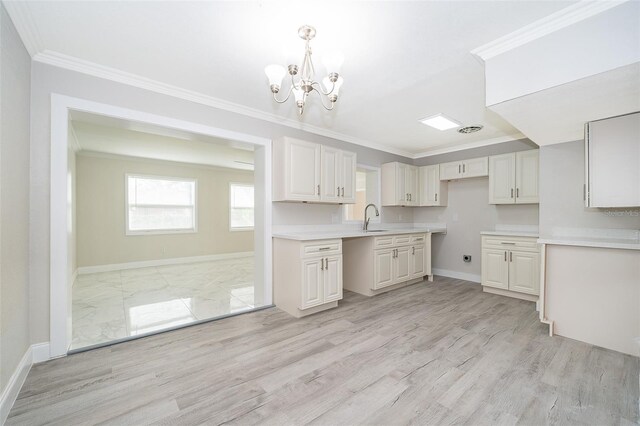 3703 Wade Rd, Orlando, FL 32808 - kitchen featuring a sink, a chandelier, baseboards, crown molding, and light wood finished floors