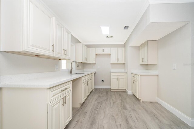 3703 Wade Rd, Orlando, FL 32808 - kitchen with a sink, light wood finished floors, and baseboards