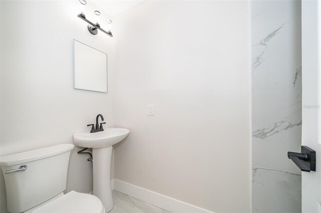3703 Wade Rd, Orlando, FL 32808 - bathroom with marble finish flooring, baseboards, and toilet
