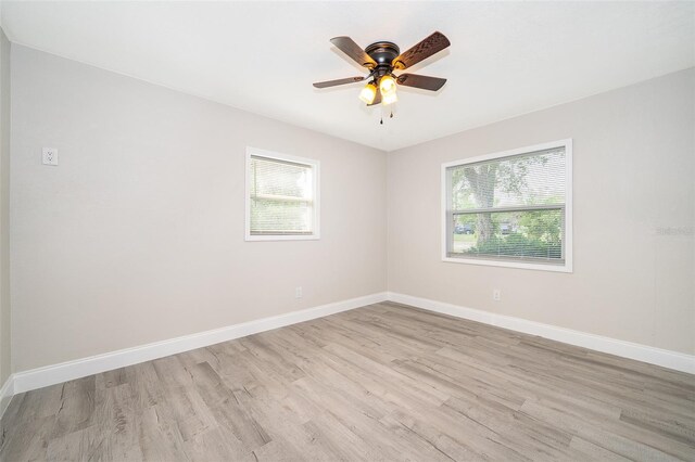 unfurnished room featuring ceiling fan, a healthy amount of sunlight, and light hardwood / wood-style flooring