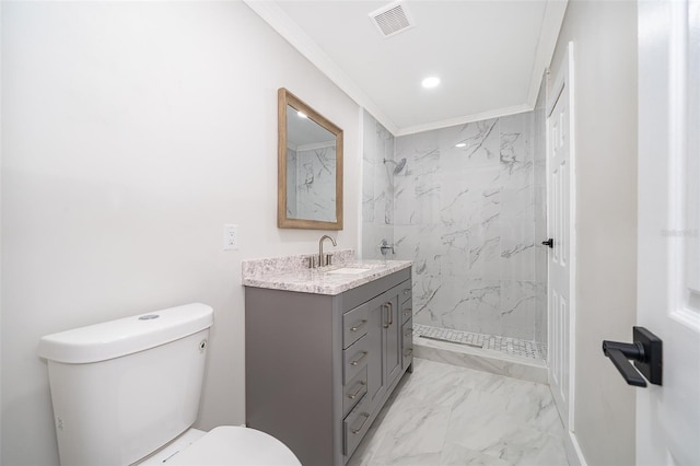 bathroom with vanity, toilet, ornamental molding, and a tile shower