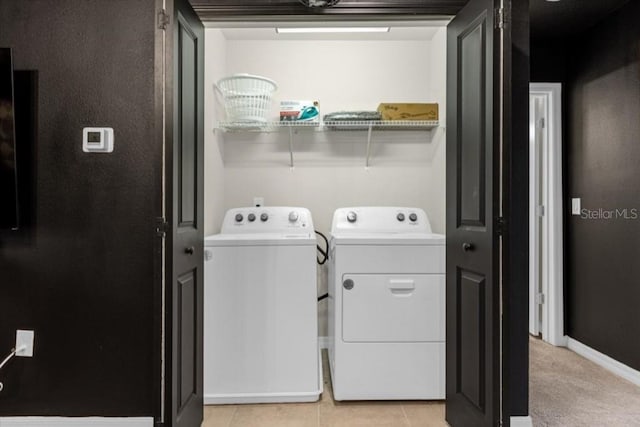 washroom with washer and dryer and light tile patterned floors