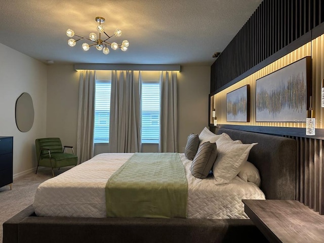 bedroom featuring carpet, a textured ceiling, and an inviting chandelier