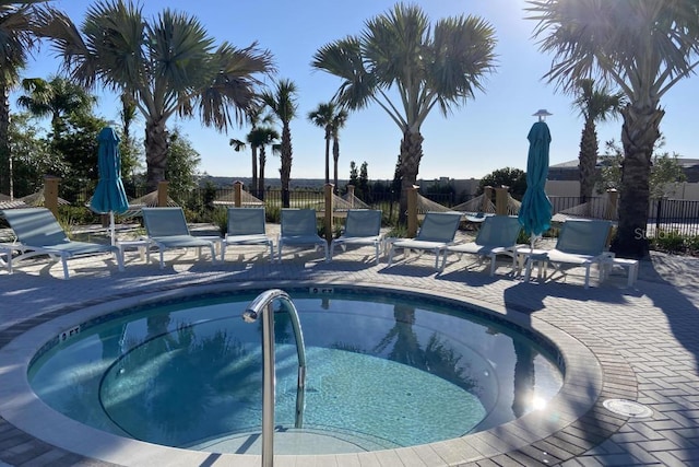 view of swimming pool with a community hot tub and a patio area