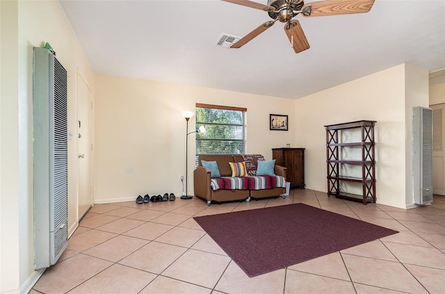 sitting room featuring light tile patterned floors and ceiling fan