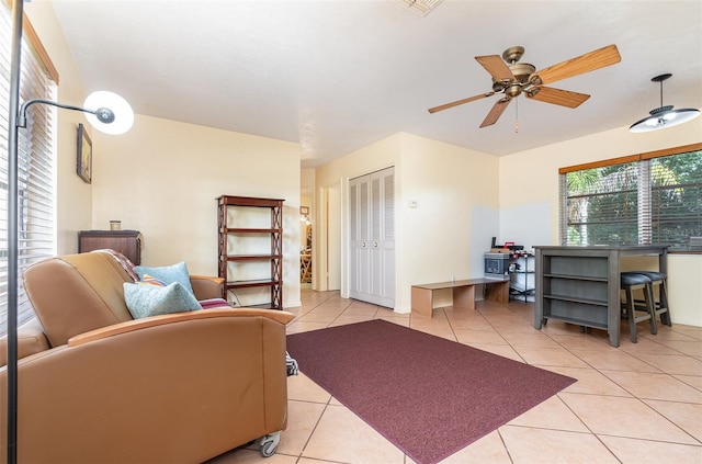 living room featuring ceiling fan and light tile patterned floors