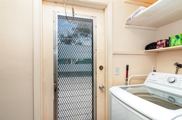 clothes washing area featuring washer / dryer