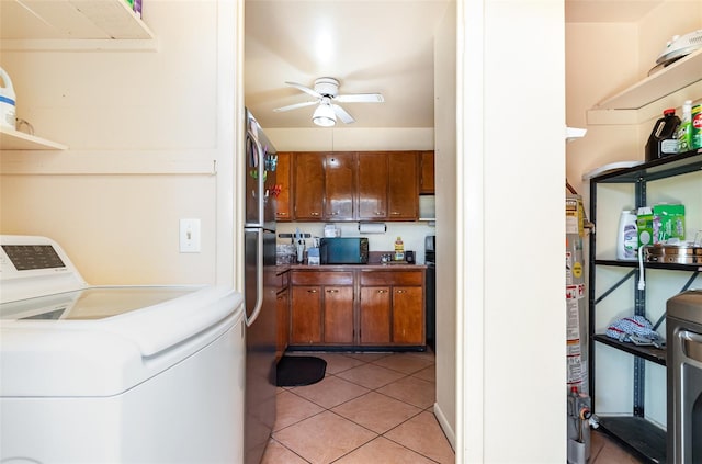 kitchen with stainless steel fridge, ceiling fan, light tile patterned flooring, and water heater