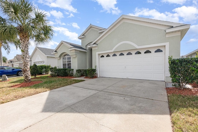 single story home featuring a garage and a front lawn