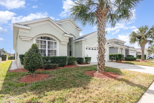 ranch-style home featuring a garage and a front lawn