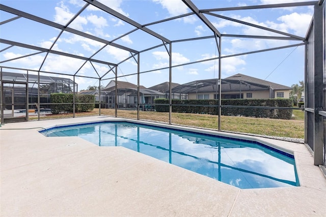 view of swimming pool featuring a lanai and a patio area