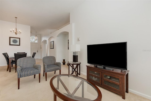 living room featuring a notable chandelier and light colored carpet