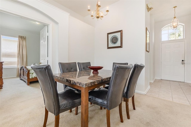 dining area with light carpet and a notable chandelier