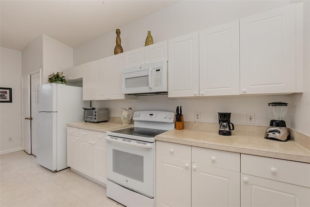 kitchen featuring white cabinetry and white appliances