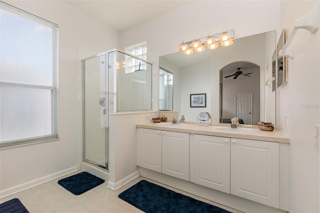 bathroom featuring vanity, an enclosed shower, and ceiling fan