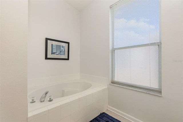 bathroom featuring tiled tub