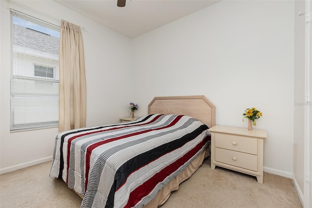 bedroom featuring light carpet and ceiling fan