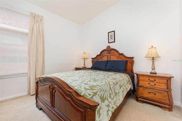 bedroom featuring light carpet and vaulted ceiling