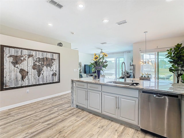 kitchen featuring sink, an inviting chandelier, stainless steel dishwasher, pendant lighting, and light wood-type flooring