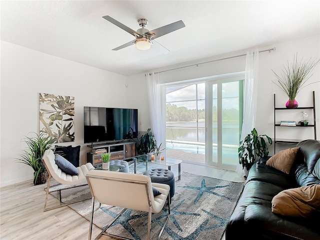 living room featuring light hardwood / wood-style floors and ceiling fan