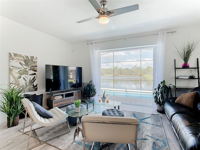 living room featuring ceiling fan and hardwood / wood-style flooring