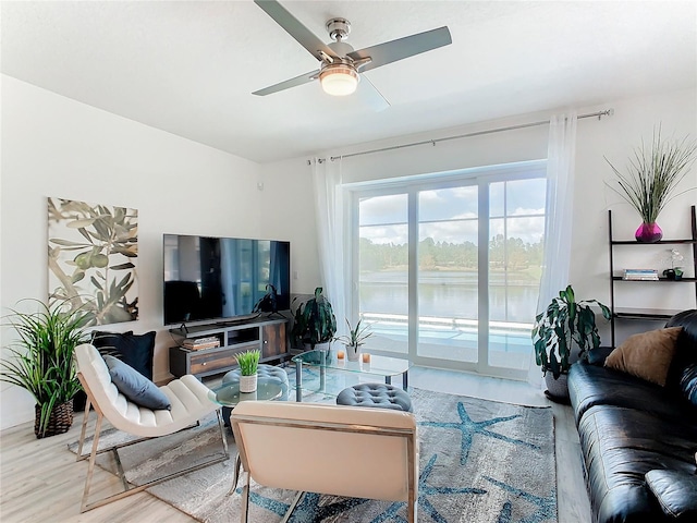 living room featuring hardwood / wood-style floors and ceiling fan