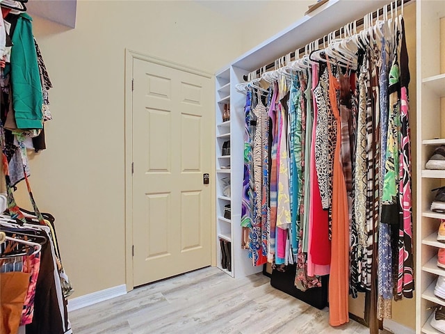 walk in closet featuring light hardwood / wood-style flooring