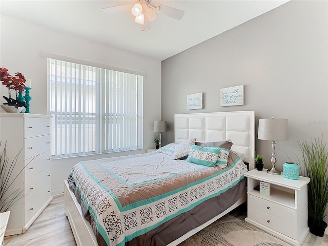 bedroom with ceiling fan and light hardwood / wood-style floors