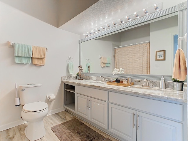 bathroom with a shower with curtain, vanity, toilet, and wood-type flooring