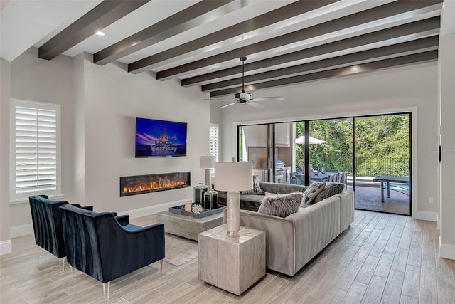 living room with beam ceiling, ceiling fan, and light hardwood / wood-style floors