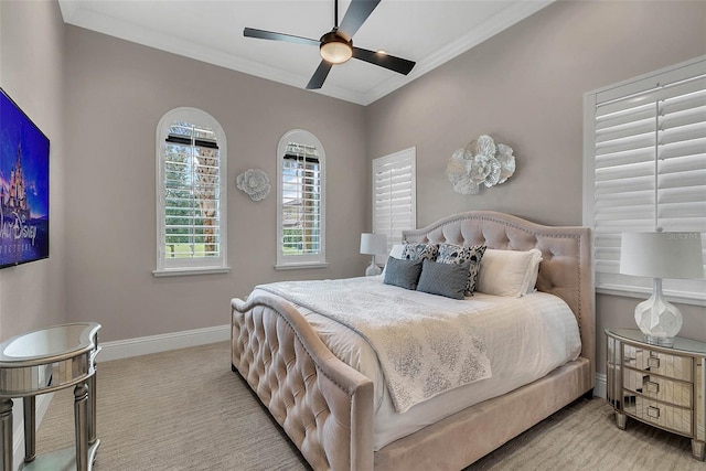 bedroom featuring ceiling fan, ornamental molding, and light carpet