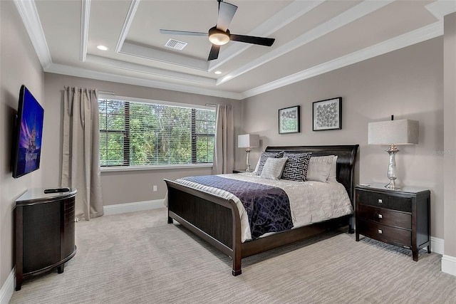 bedroom with a raised ceiling, ceiling fan, light colored carpet, and ornamental molding