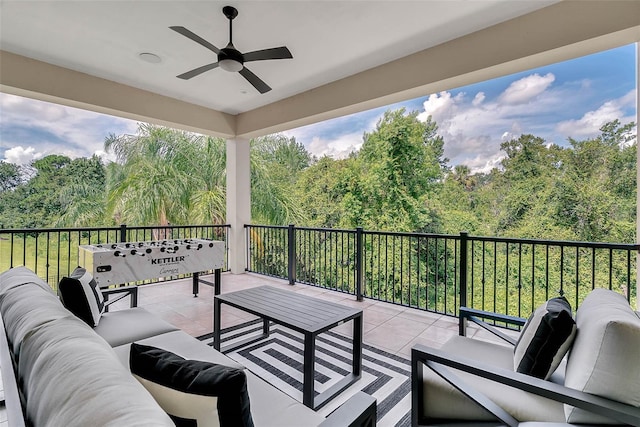 view of patio with an outdoor living space and ceiling fan