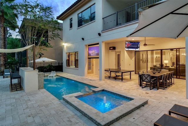 view of pool featuring a patio area, a bar, and an in ground hot tub