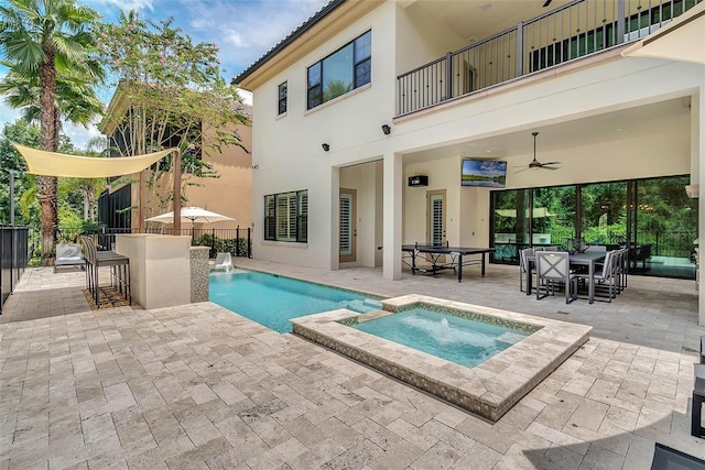 view of swimming pool featuring an in ground hot tub, a bar, ceiling fan, and a patio area