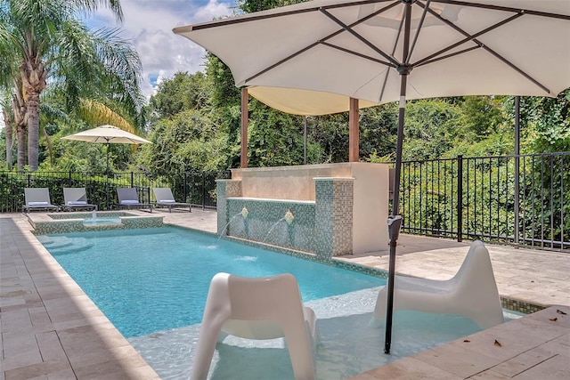 view of pool featuring pool water feature and a patio