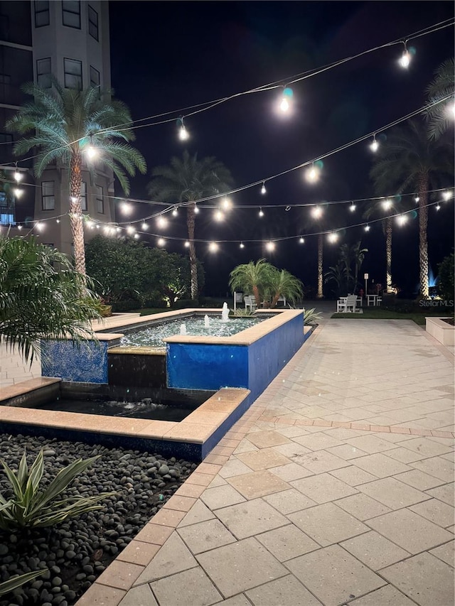 view of pool at night