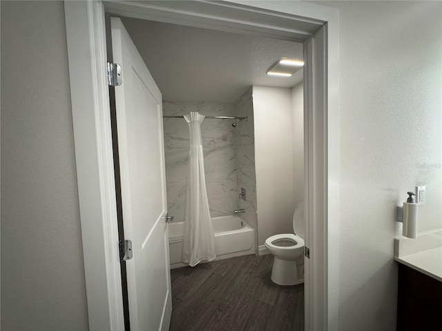 bathroom with shower / bath combo, toilet, wood-type flooring, and a textured ceiling