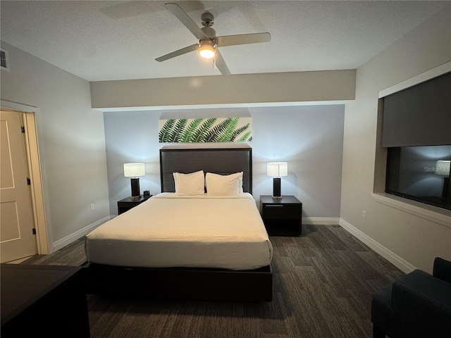 bedroom featuring ceiling fan, dark hardwood / wood-style flooring, and a textured ceiling