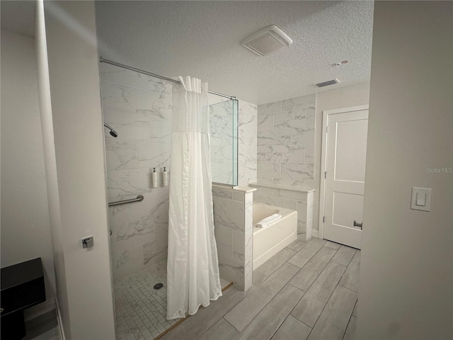 bathroom with a textured ceiling and plus walk in shower