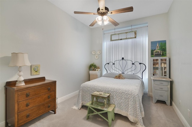 bedroom with ceiling fan and light colored carpet