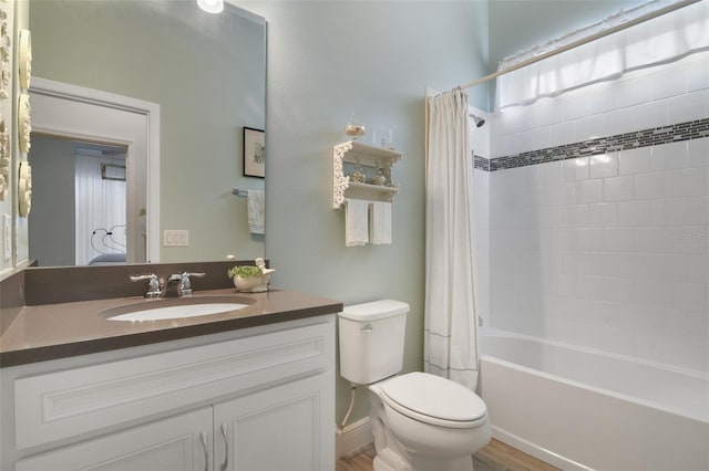 full bathroom with vanity, shower / bath combo, hardwood / wood-style flooring, and toilet