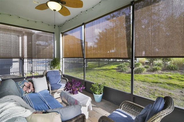 sunroom / solarium featuring ceiling fan