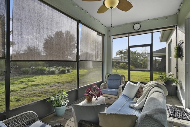 sunroom / solarium featuring ceiling fan