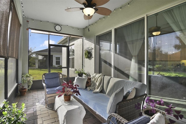 sunroom featuring ceiling fan