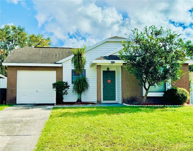 single story home featuring a front lawn and a garage