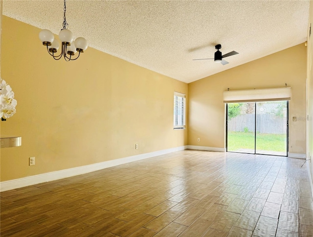 unfurnished room with hardwood / wood-style floors, a textured ceiling, ceiling fan with notable chandelier, and vaulted ceiling