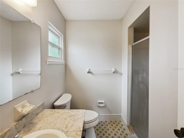 bathroom with a textured ceiling, toilet, a shower with shower door, vanity, and tile patterned flooring