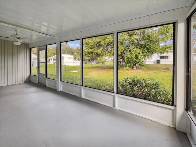 unfurnished sunroom with ceiling fan