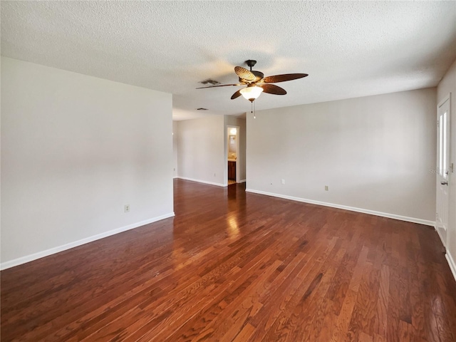 spare room with ceiling fan, a textured ceiling, and dark hardwood / wood-style flooring